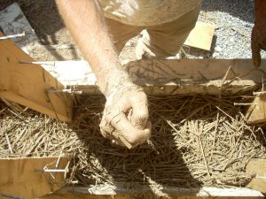 Tamping straw/clay insulation
